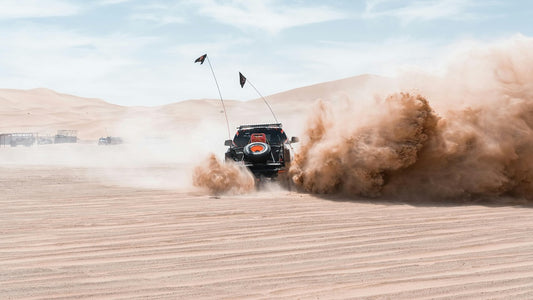 "4x4 vehicle dune bashing in the golden sands of Dubai desert"